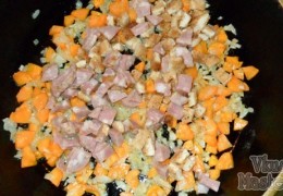 Нарезать приготовленные для солянки мясопродукты, потушить вместе с луком и морковкой 2-3 минуты.